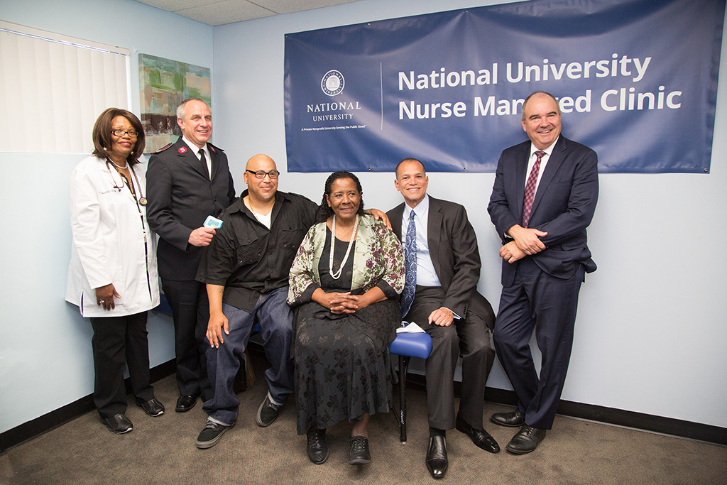 A group of people pose for the opening of two new nurse-managed clinics in Los Angeles.