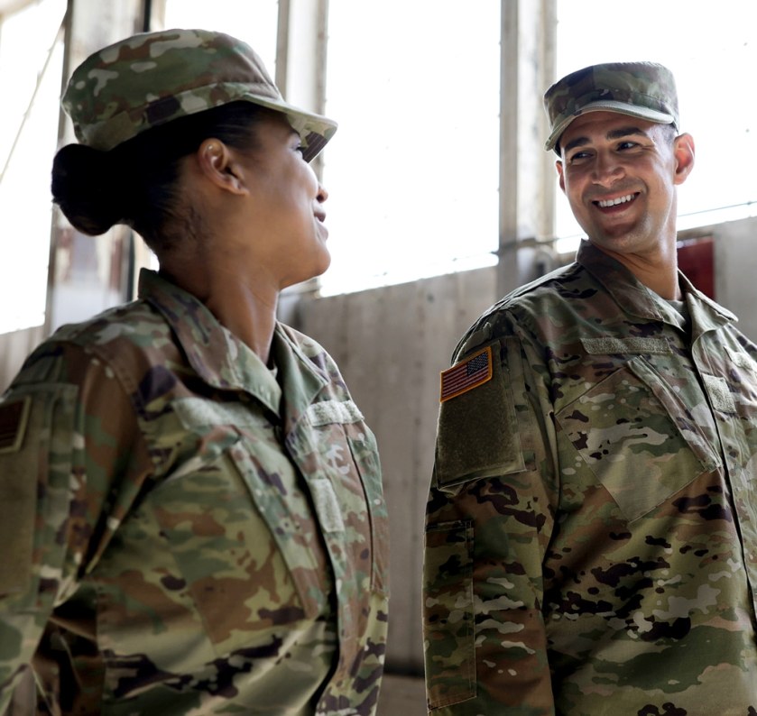 two service members in uniform talking with each other