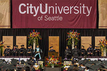 CityU President Randy Frisch addresses graduates at the Key Arena on June 17.