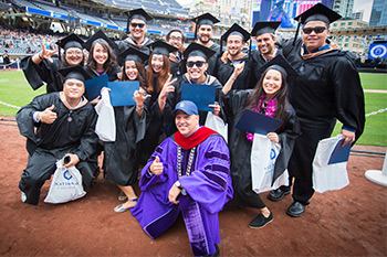 Chancellor Cunningham and NU grads celebrate on field at Petco Park.