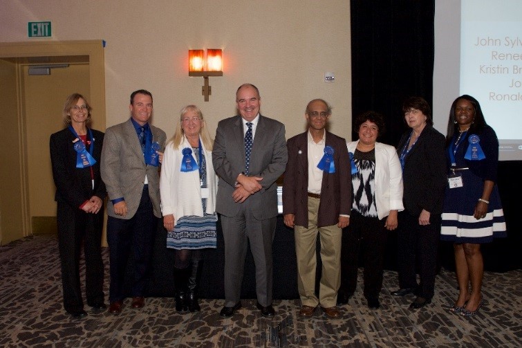 President Andrews with NU Faculty members at the 2017 Spring Symposium