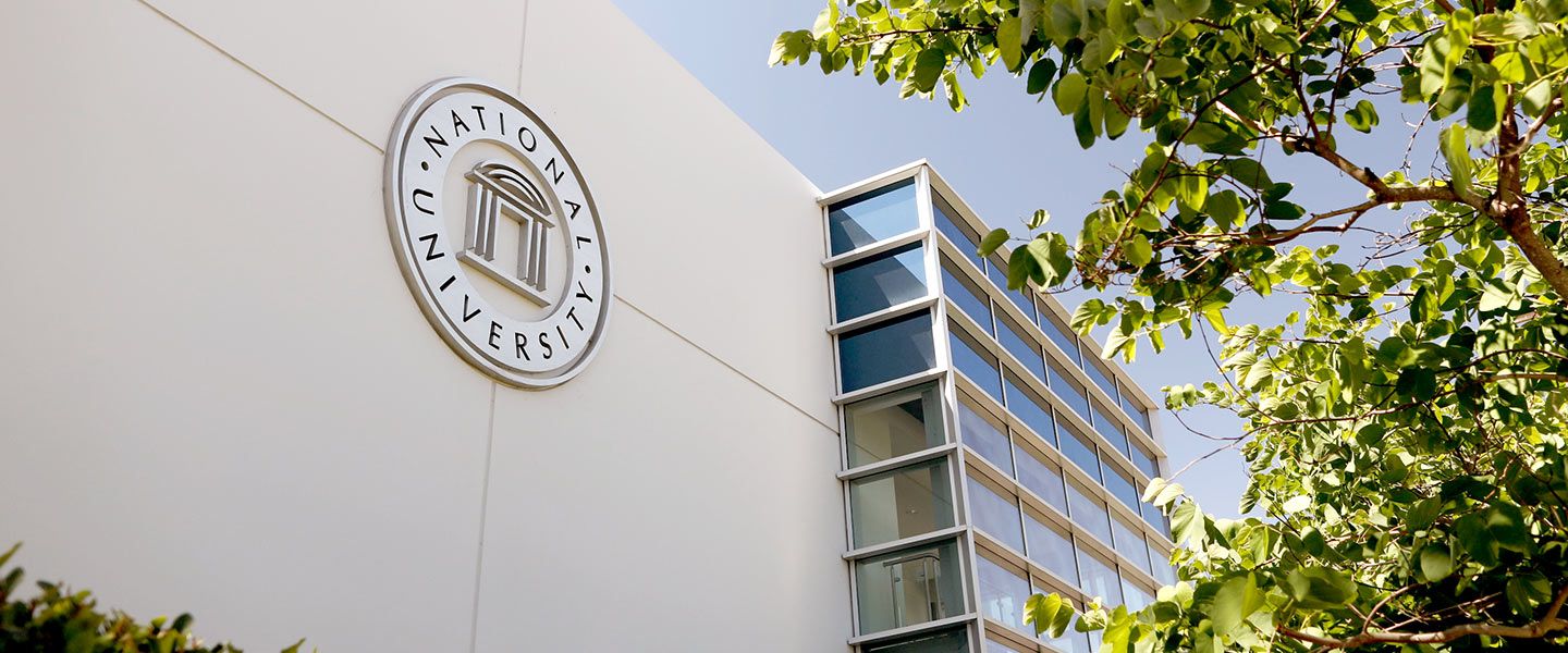 National University facade showing the old logo on the building. The Helix Electric scholarship is great for working adults.