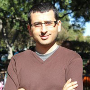 Dr. Esmaeil Atashpaz-Gargri stands outside with his arms crossed over his chest.