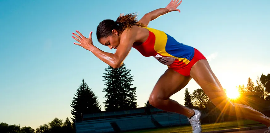 a woman in a colorful uniform sprints