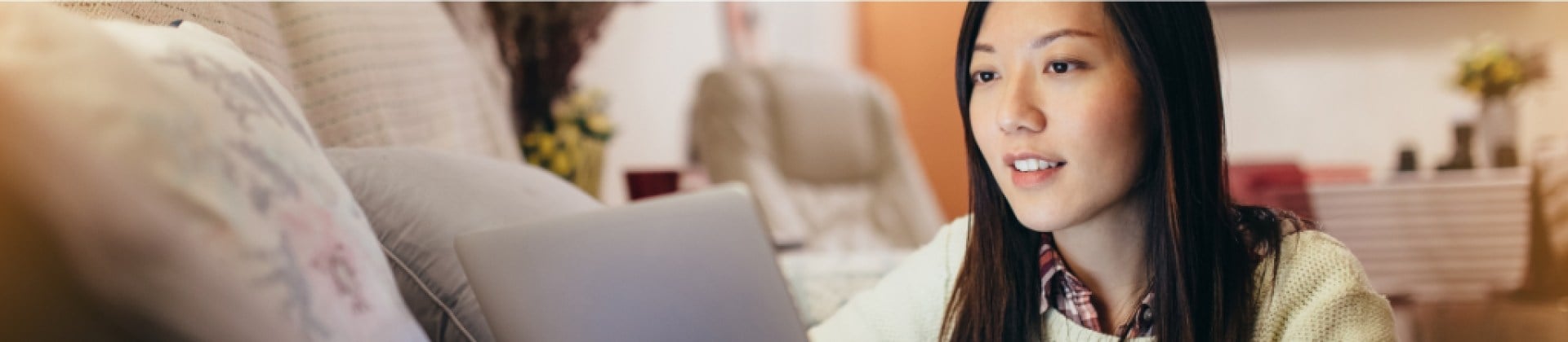 woman works on a laptop in a living room