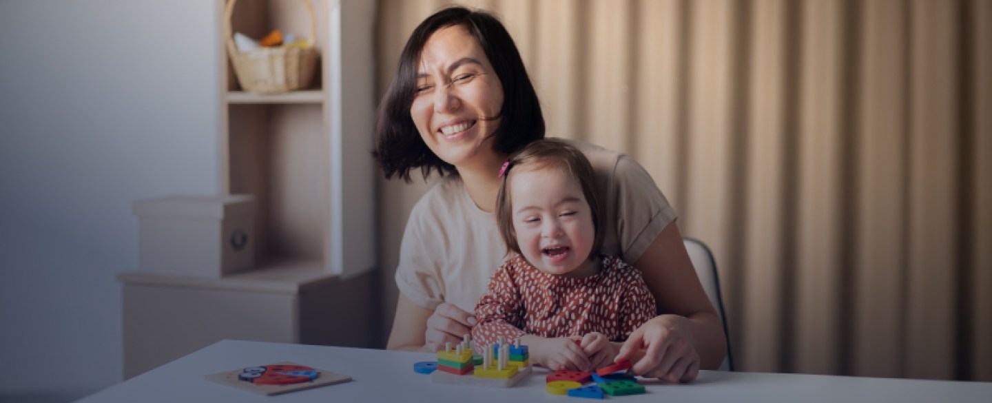 Mother holding her child at kitchen table