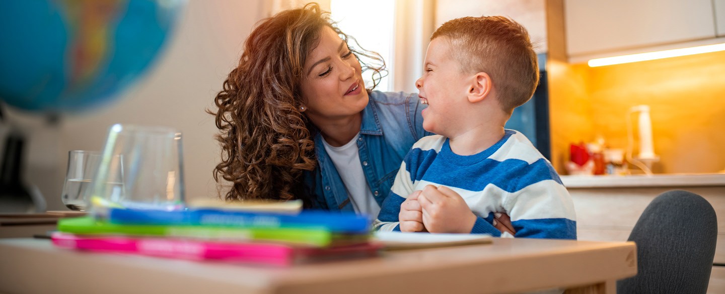 mother and child laughing together in kitchen