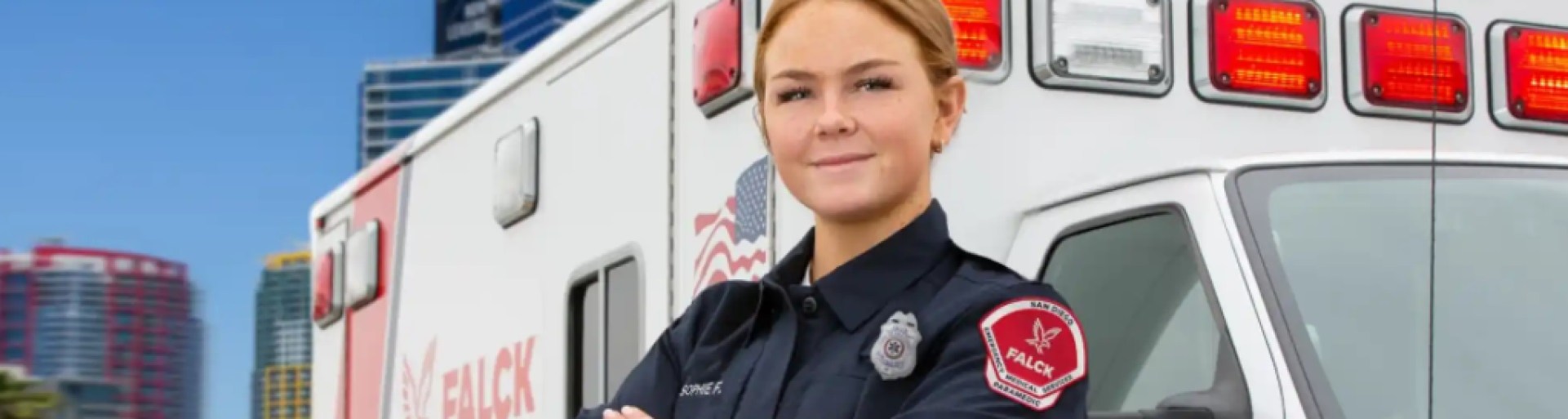 female firefighter standing in front of a ambulance. 