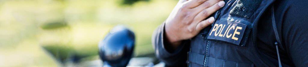 closeup of a police officer next to their motorcycle