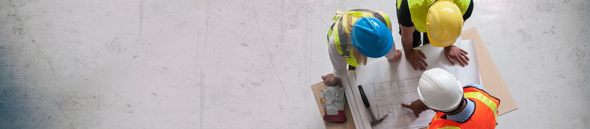 Construction worker looking at blueprints on a job site