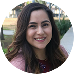 Headshot of Erika Torres, 2021 Graduate, a woman with long brown hair who is wearing a pink blouse.