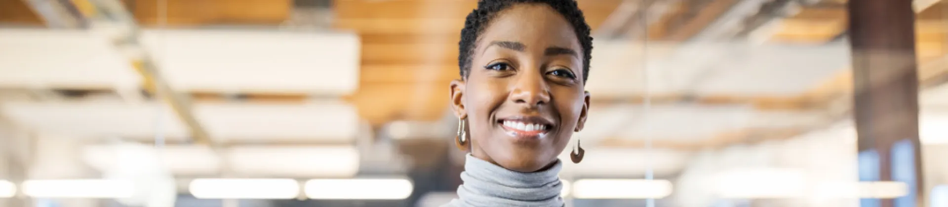 woman in office sitting smiling at camera