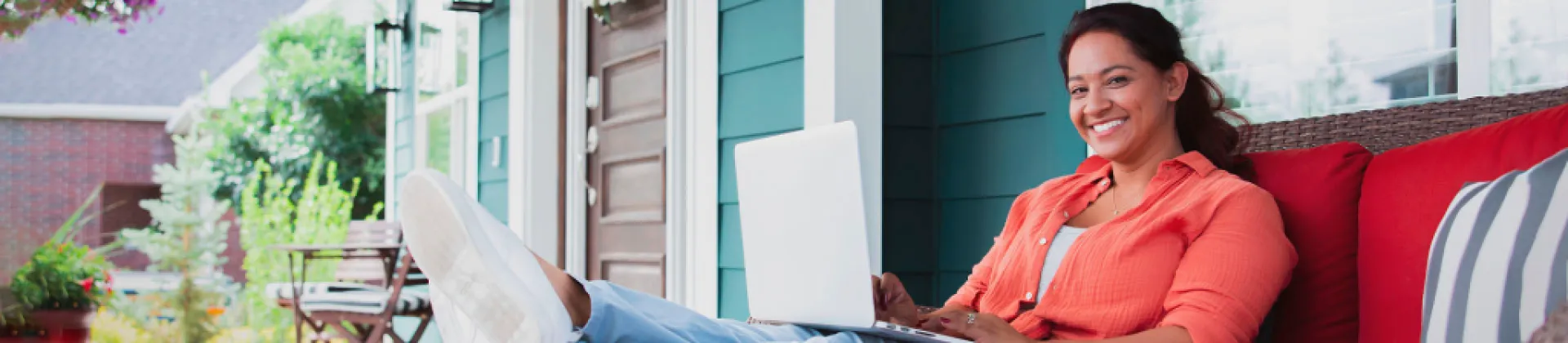 Person sitting on porch with laptop computer