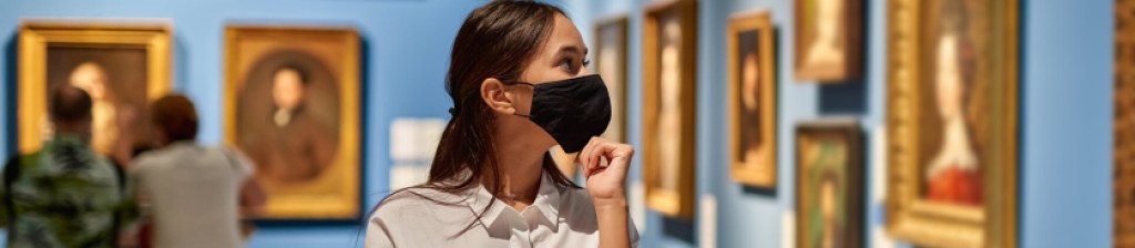 person wearing a face mask in a art museum