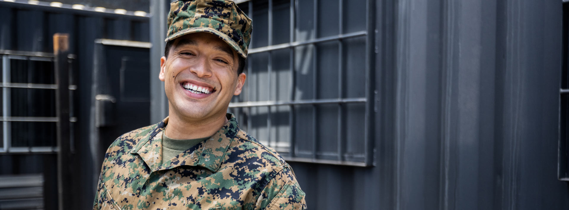A man in a military uniform smiles widely
