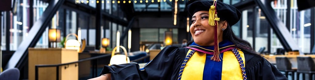 woman graduate smiling as she looks to her right