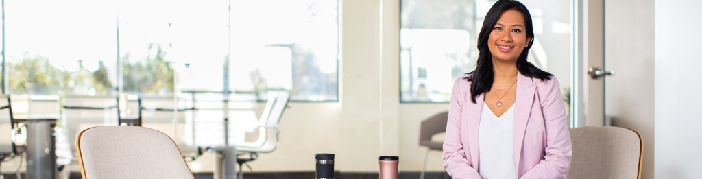 Person posing in office lobby