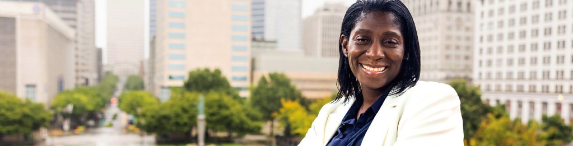 Woman sitting downtown outside office buildings