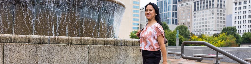 Woman walking by fountain