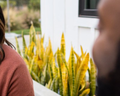 woman smiling at man, outside