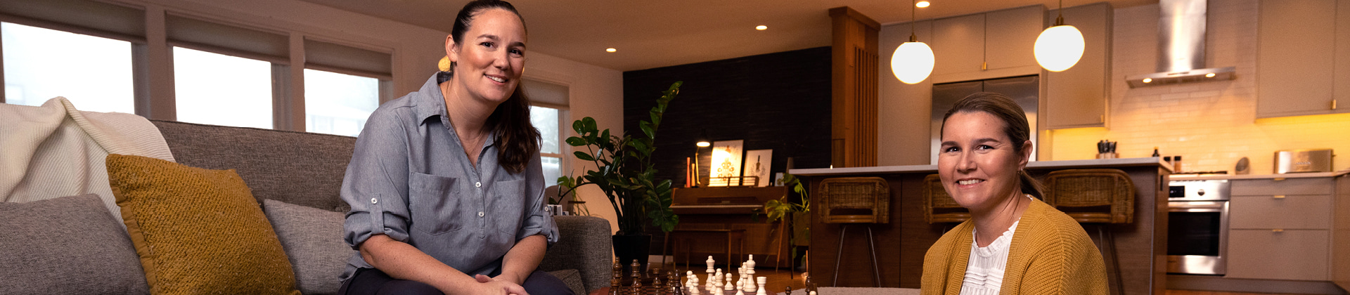 LGBTQ couple playing chess in their home