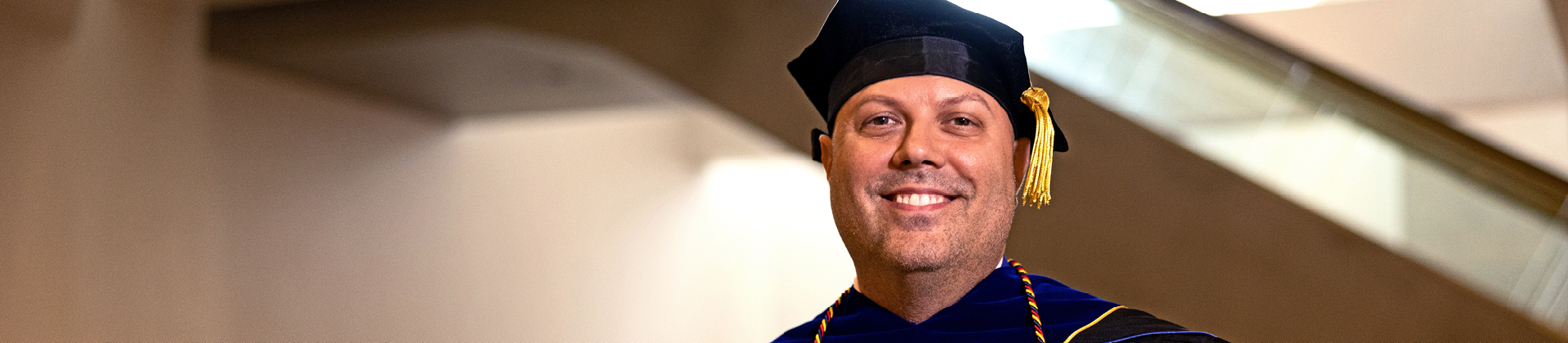 Person wearing graduation cap and gown receiving their Master’s Degree in Child & Adolescent Developmental Psychology