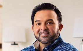 Person sitting at the table working on laptop at home