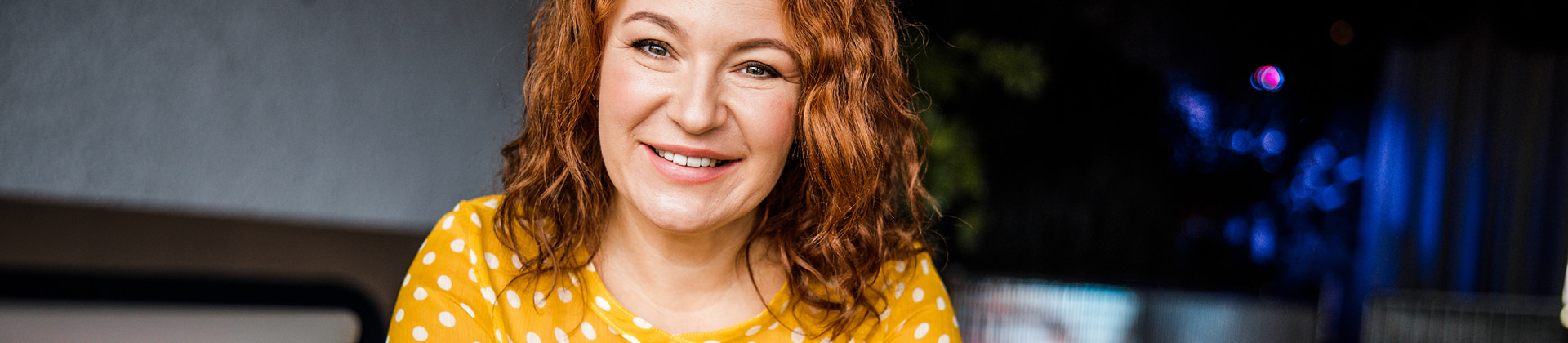 woman in yellow shirt smiling