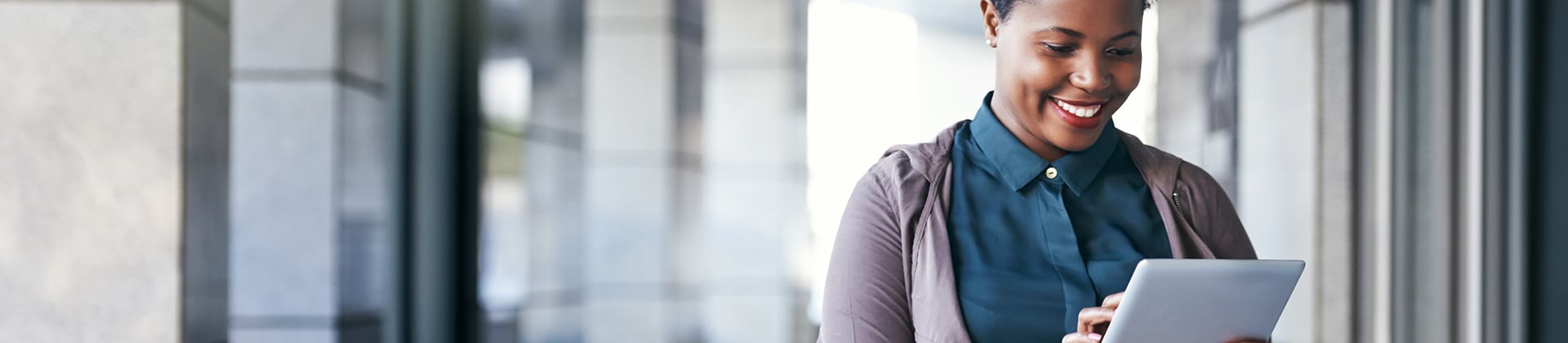 person smiling and looking tablet