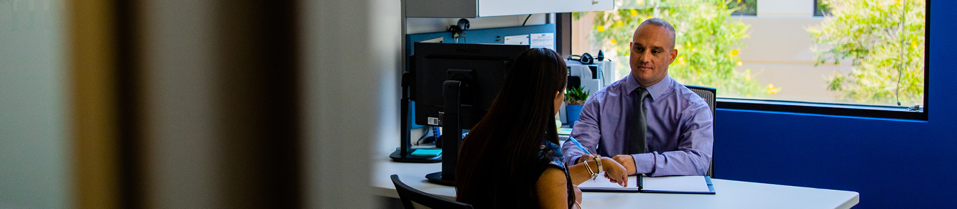 two people chatting in their office