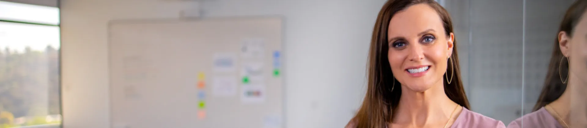 person in office with whiteboard in the background