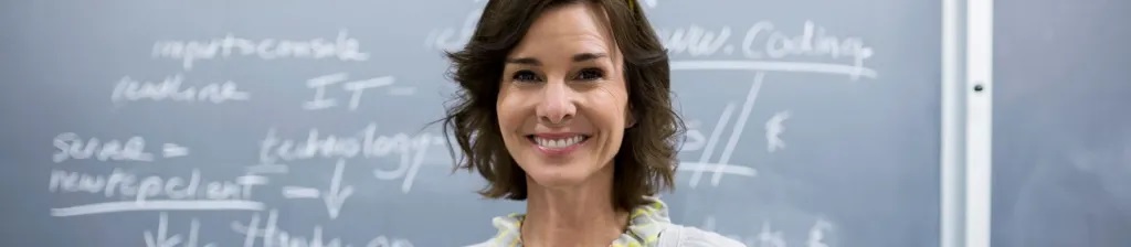 female teacher smiles at camera