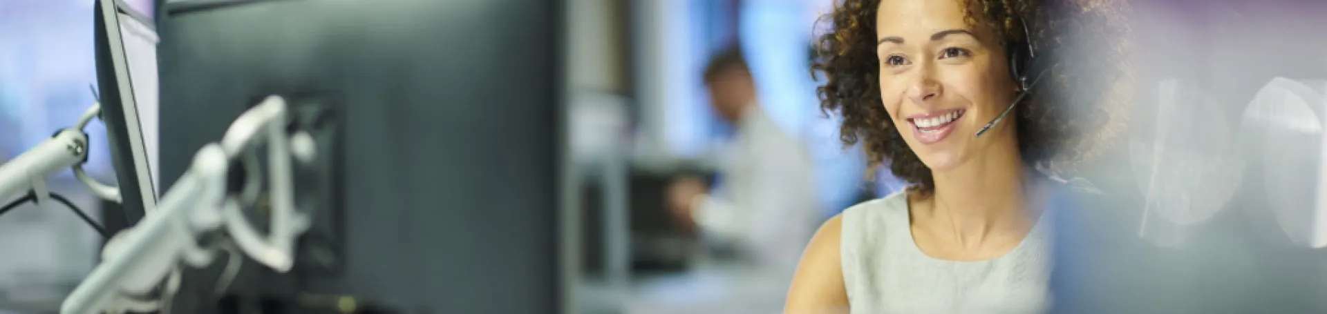 woman wearing a headset working on a computer science degree