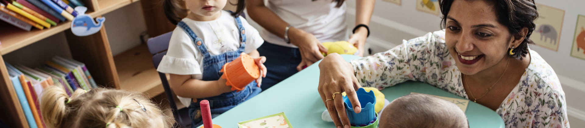 Teacher at table with children in classroom