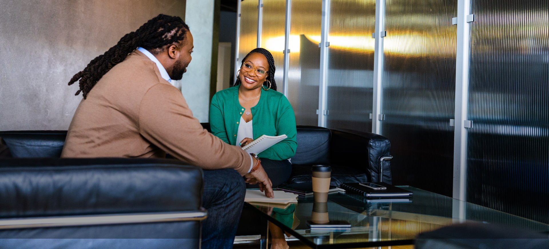 two people talk in a waiting room