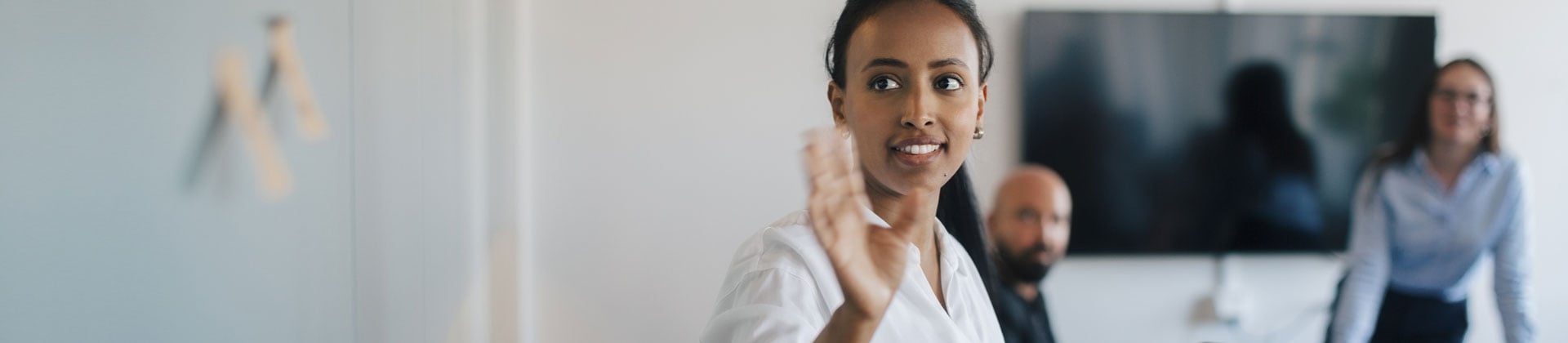 woman greets someone out of frame