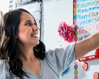 Teacher pointing at whiteboard in classroom