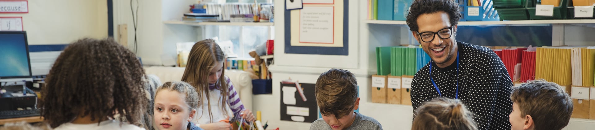 A teacher with several children in a classroom