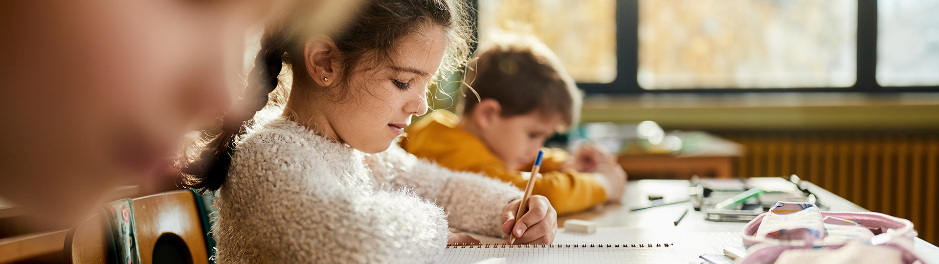 Children work on a writing assignment