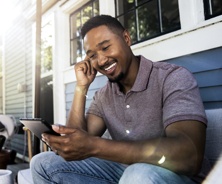 man in a polo shirt looks at his phone 
