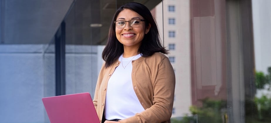 woman outside with red laptop on her lap