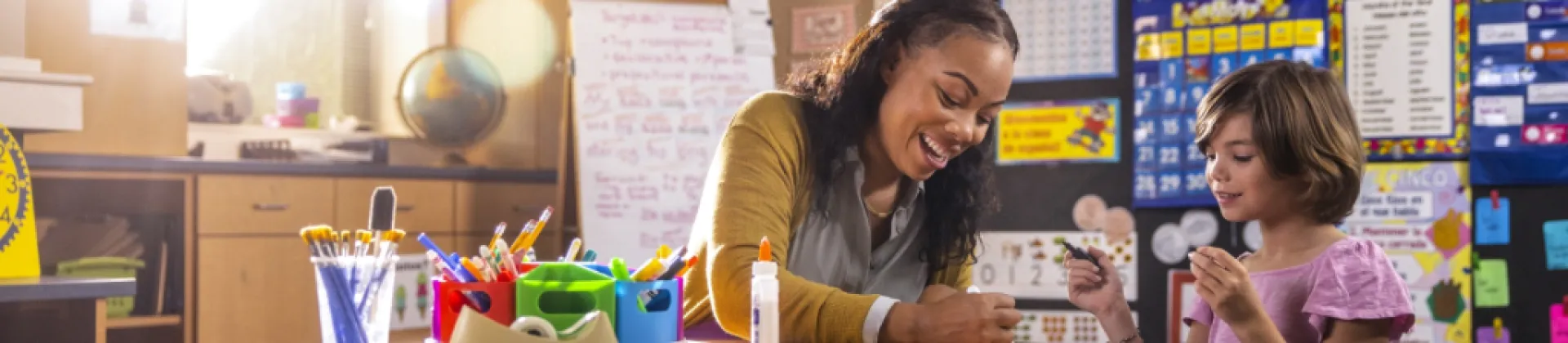 teacher doing arts and crafts with student