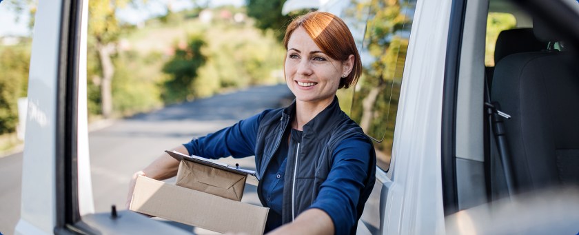 USPS deliver driver holding packages