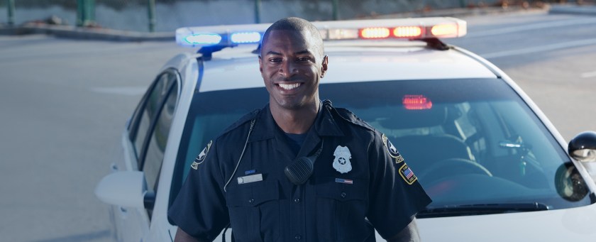 police officer in front of squad car