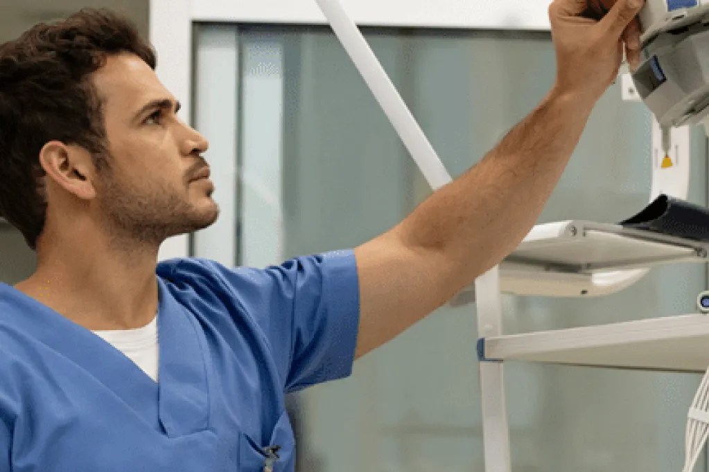 Nurse in hospital changing settings on a machine
