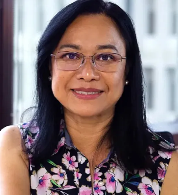 woman smiling at camera at desk