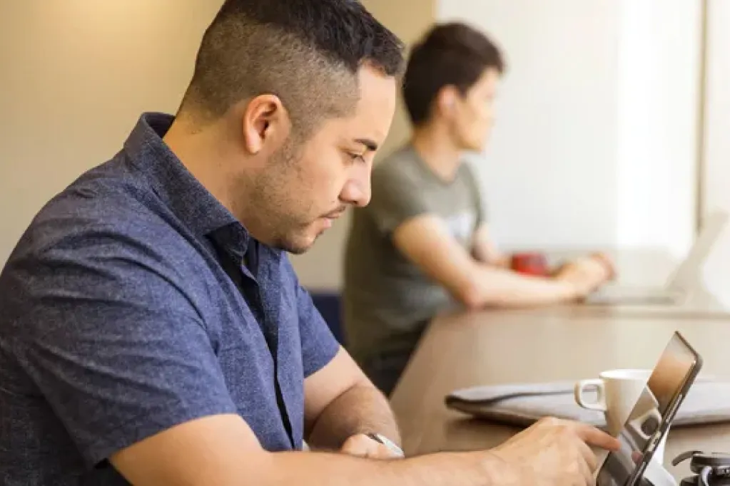 NU cybersecurity students at laptops in class