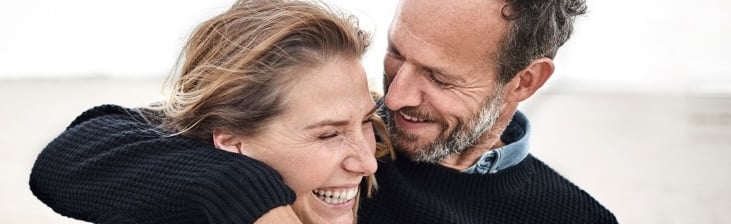 couple holding each other on the beach