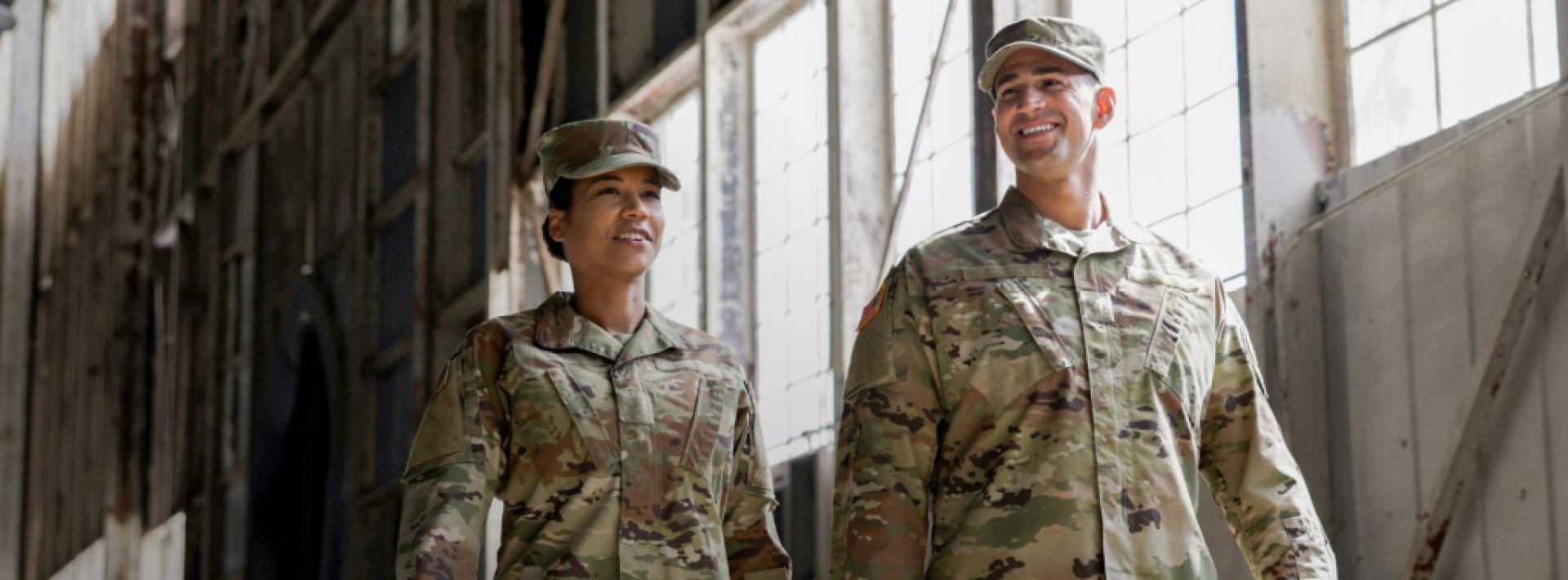 two military members walking it hanger in uniforms