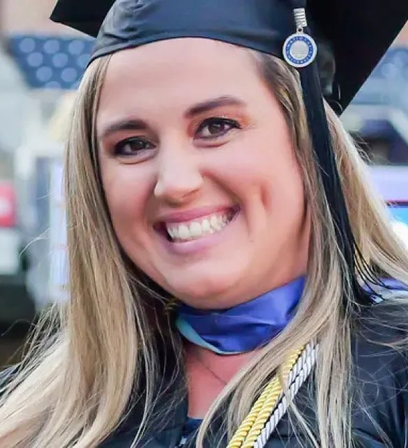 NU graduate in cap and gown